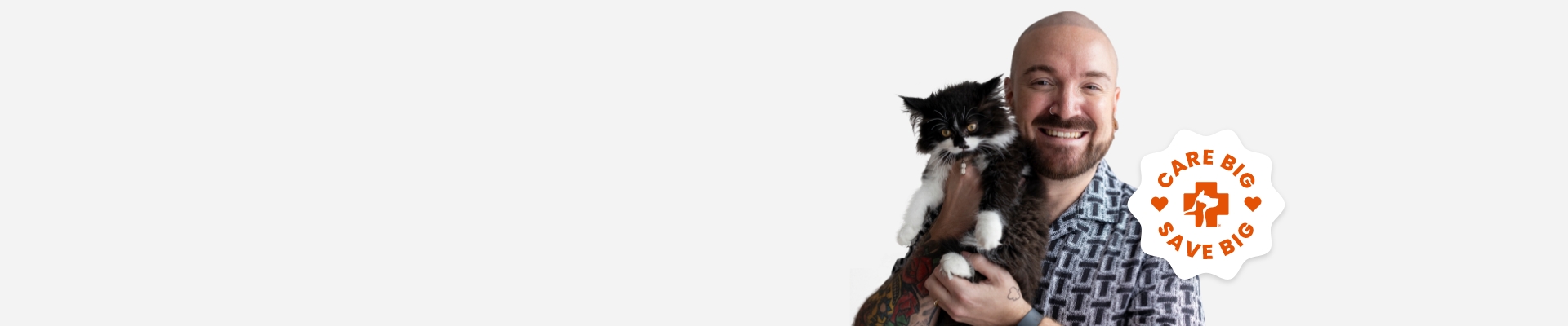 A man holding a cat by his shoulders